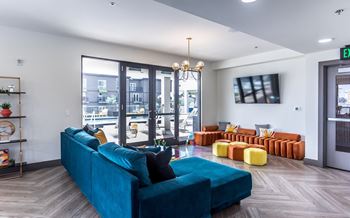 a living room with a blue couch and a tv